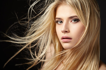 Portrait of blonde girl with fluttering hair - obrazy, fototapety, plakaty