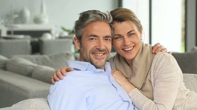 Mature couple relaxing in sofa at home