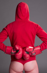 Woman fighting fit and wearing red boxing gloves