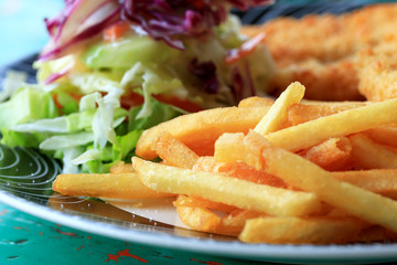 French fries and salad vegetables.