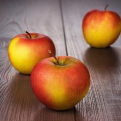 fresh red apples on brown wooden table
