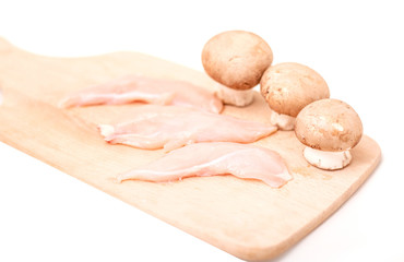 Sliced chicken breast with mushrooms for cooking