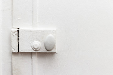 closed door with vintage white painted lock
