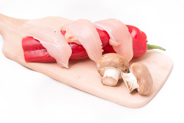 Sliced chicken breast with mushrooms, peppers for cooking