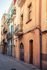 Narrow empty street view of Tarragona. Vintage stylized
