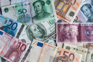 Fototapeta na wymiar Chinese, American and European paper currencies background