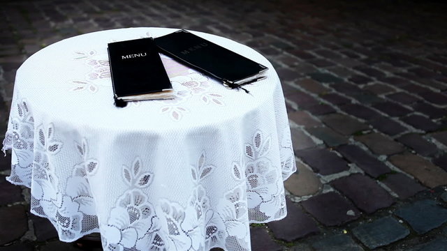 Alone table on the old town street with MENU