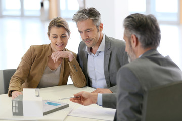 Mature couple meeting architect for construction project