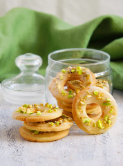 lemon cookies in the form of rings with pistachios and icing