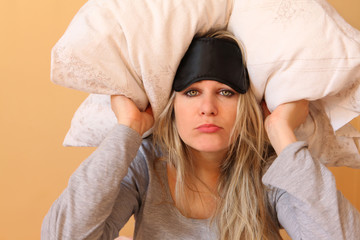 Young women with pillow and sleeping mask