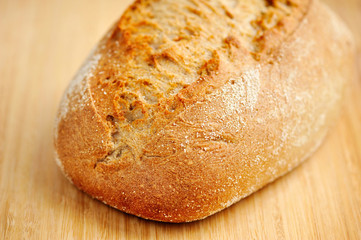 Freshly baked traditional bread on wooden board