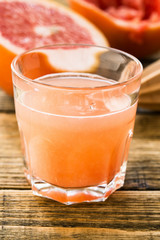 Glass of fresh organic pink grapefruit juice