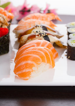 Japanese cuisine. Set of sushi nigiri on white plate.