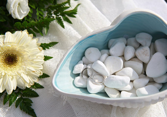 Wedding rings on sea pebbles