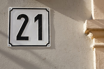 Ornament number on the wall of the house.