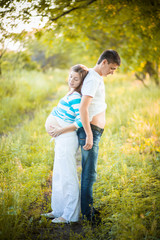 Pregnant couple on nature