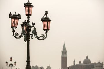 Fototapeta na wymiar old street lighter in Venice in Italy