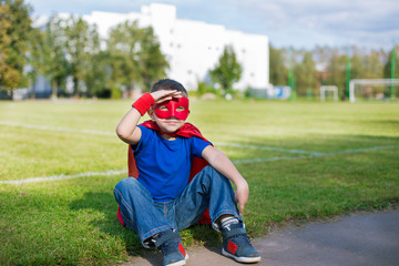 Superhero sitting and looking from under his hand