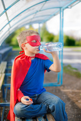 Superhero drinking water from a bottle