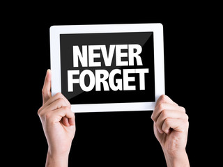 Obraz premium Tablet pc with text Never Forget isolated on black background