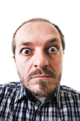 Obraz premium Surprised man in plaid shirt, eyes wide open