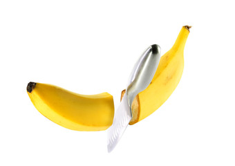 Steel knife cuts ripe banana