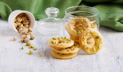 lemon cookies in the form of rings with pistachios and icing