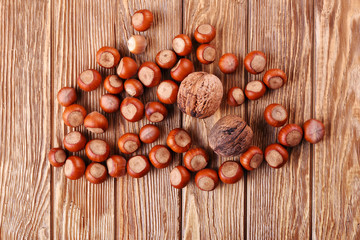 close hazelnuts and walnuts on wood table