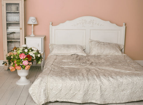 cozy stylish vintage corner of the bedroom with flowers