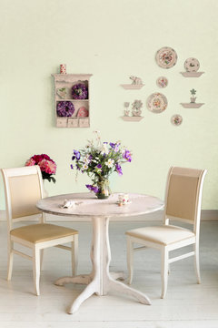 dining room interior with flowers decorative plates blue wall an