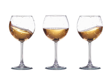 Set of glasses with white wine splash isolated on white