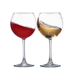 Red and white wine splash wave in glass isolated