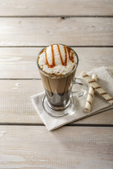 cold coffee with ice cream and caramel in a glass