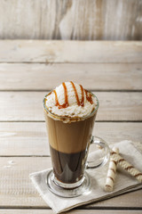 cold coffee with ice cream and caramel in a glass