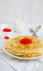 pancakes with red caviar on the white background