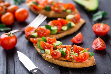 Bruschetta with tomato, avocado and herbs