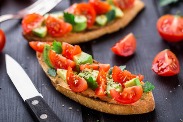 Bruschetta with tomato, avocado and herbs