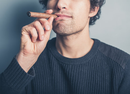 Young man smoking a cigar