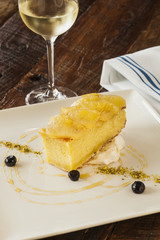 Olive oil cake topped with roasted pineapple and pistachio puree