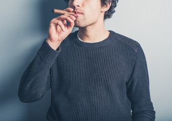 Young man smoking a cigar