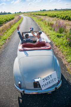 top view, A newlywed couple is driving a retro car