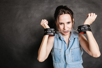 Arrest and jail. Criminal woman prisoner girl in handcuffs