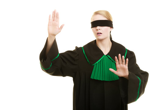 Blind justice. Woman covering eyes with blindfold