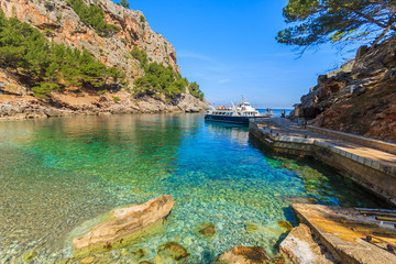 Tourist boat in beautiful Sa Calobra bay, Majorca island, Spain