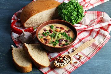 Bean soup in bowl with fresh sliced bread