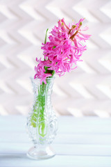 Beautiful hyacinth flower in vase on wooden table