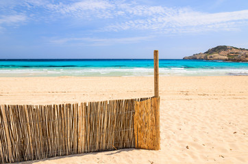 Wind fence on Cala Agulla beach, Majorca island, Spain