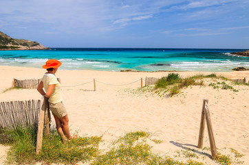 Young woman tourist on sandy Cala Agulla beach, Majorca island