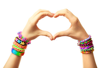 Female hands in shape of heart with bracelets isolated on white