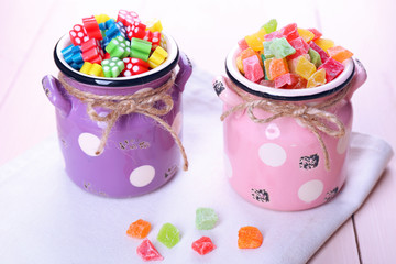 Sweet candies on color wooden table, closeup